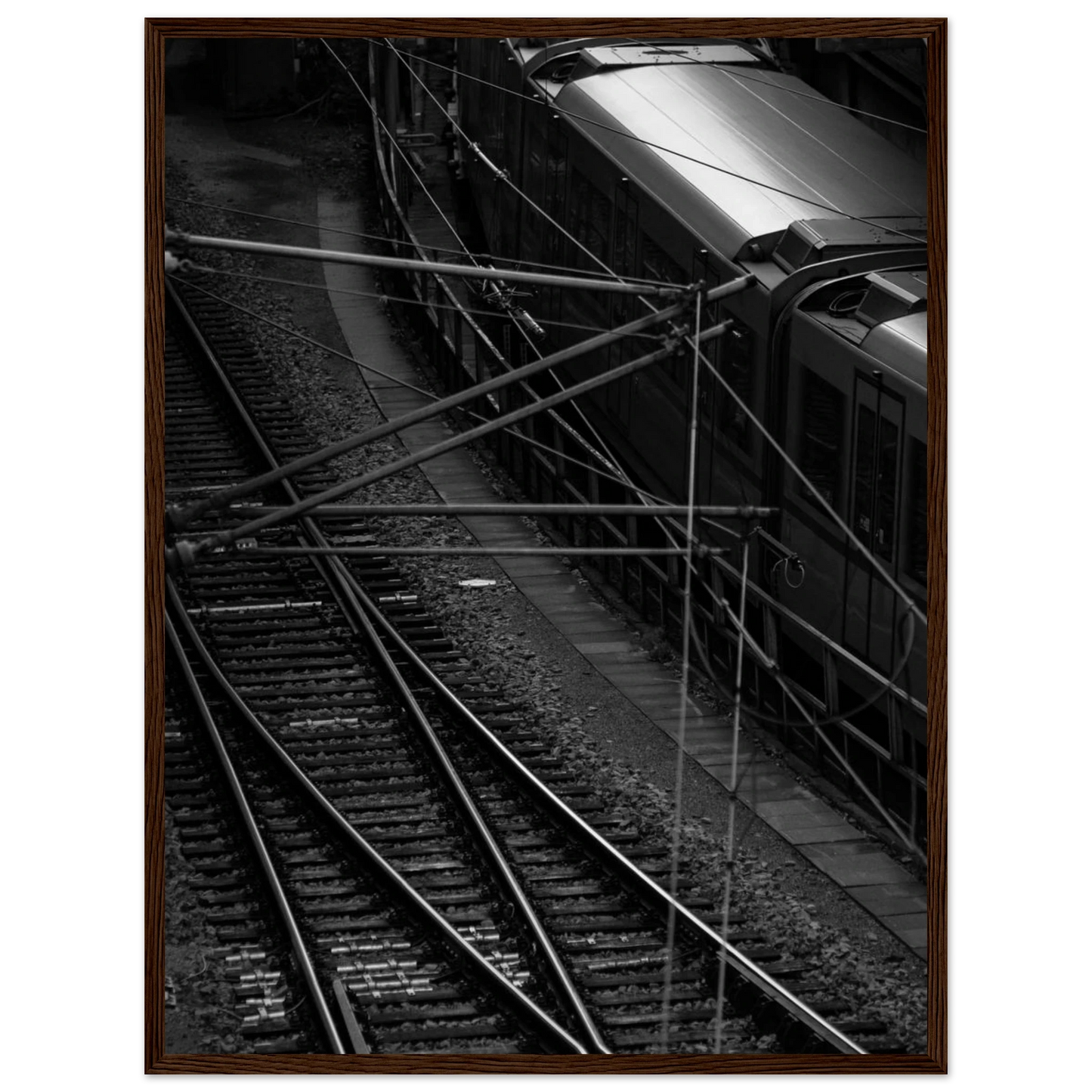Black and white aerial view of metro train and railway tracks in an urban underground or elevated rail system on wooden framed wall art