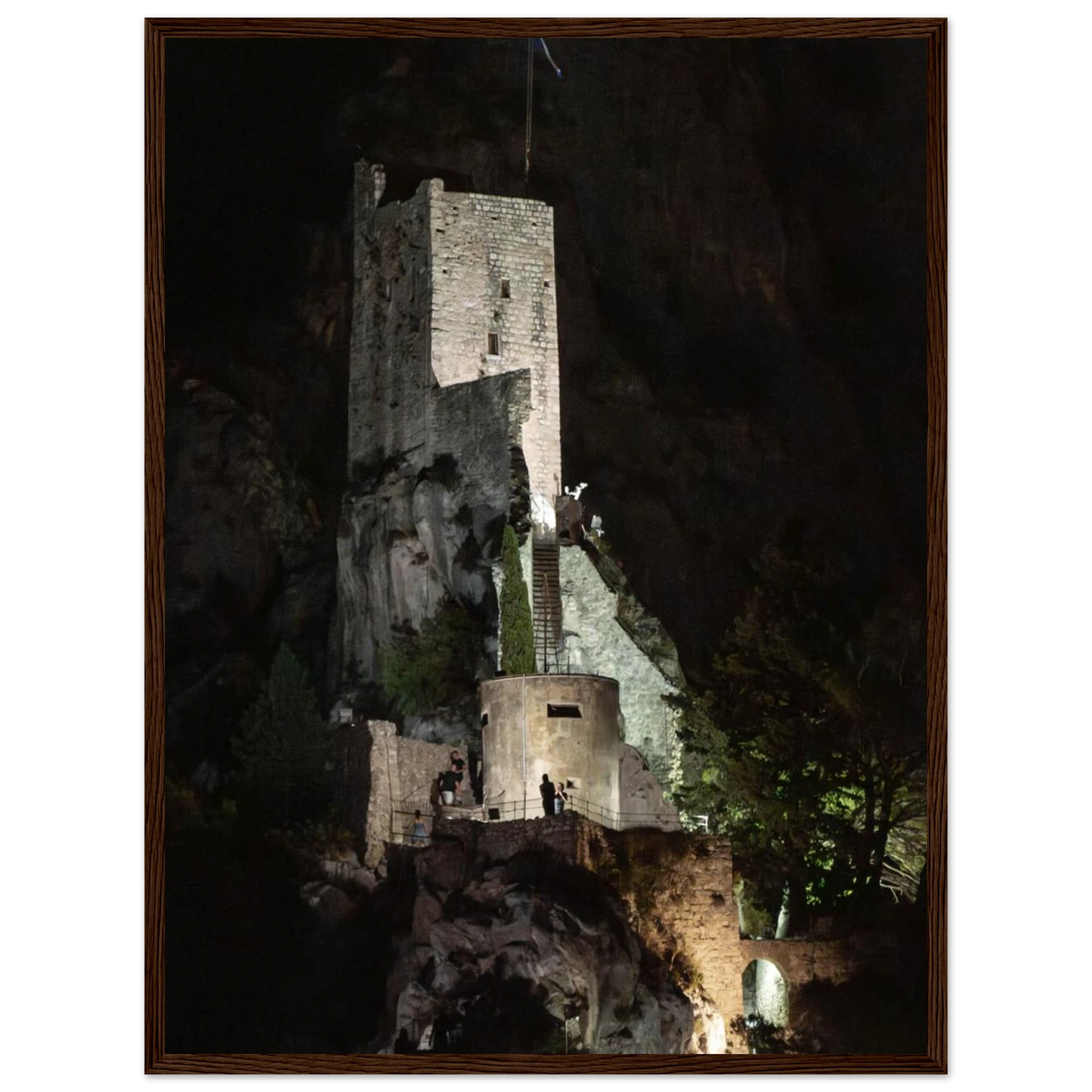 Wooden framed wall art of an ancient stone bastion decorated with green climbing plants against a dark background in Shadow Keep