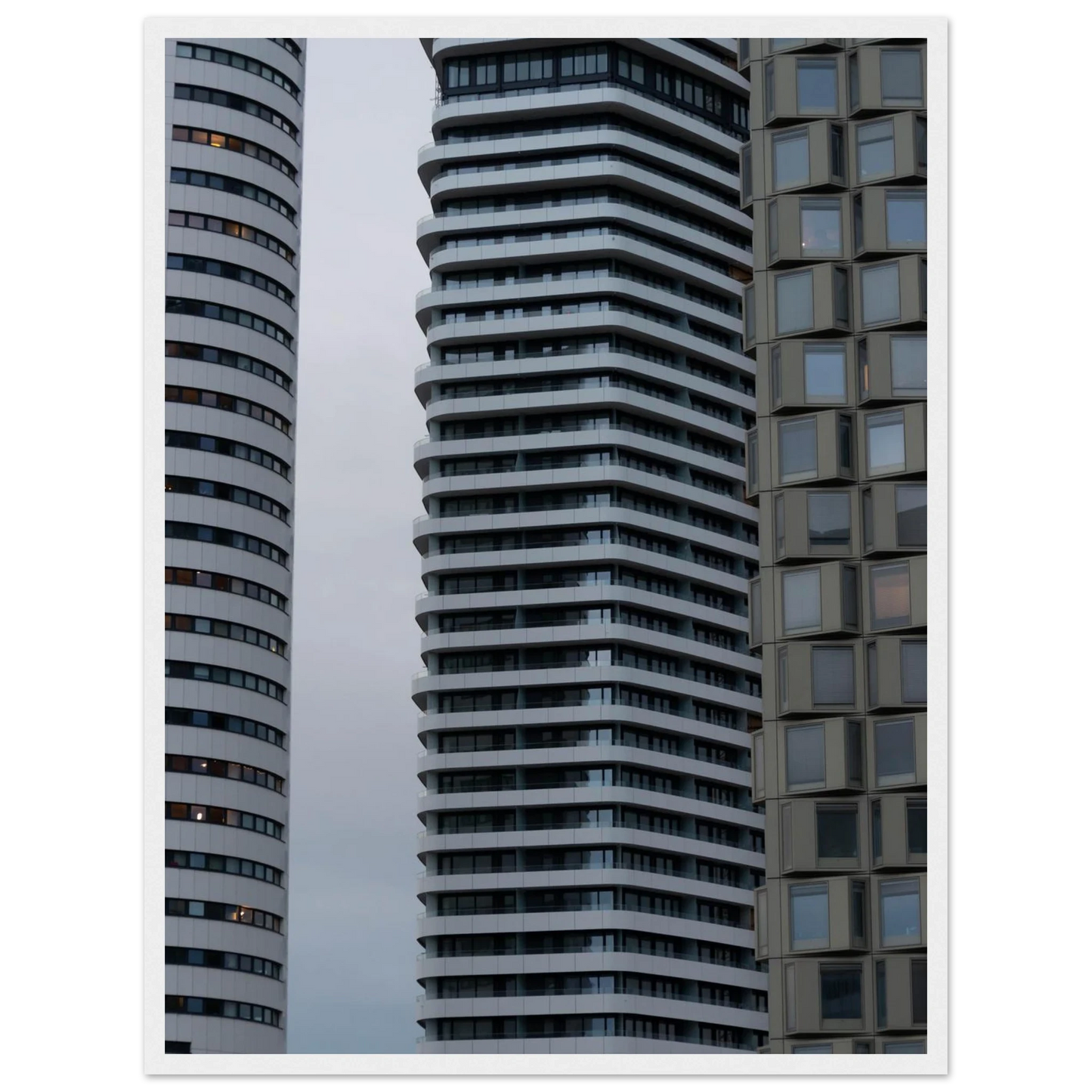Modern high rise tower buildings with glass and steel facade reaching into the sky on wodden framed wall art