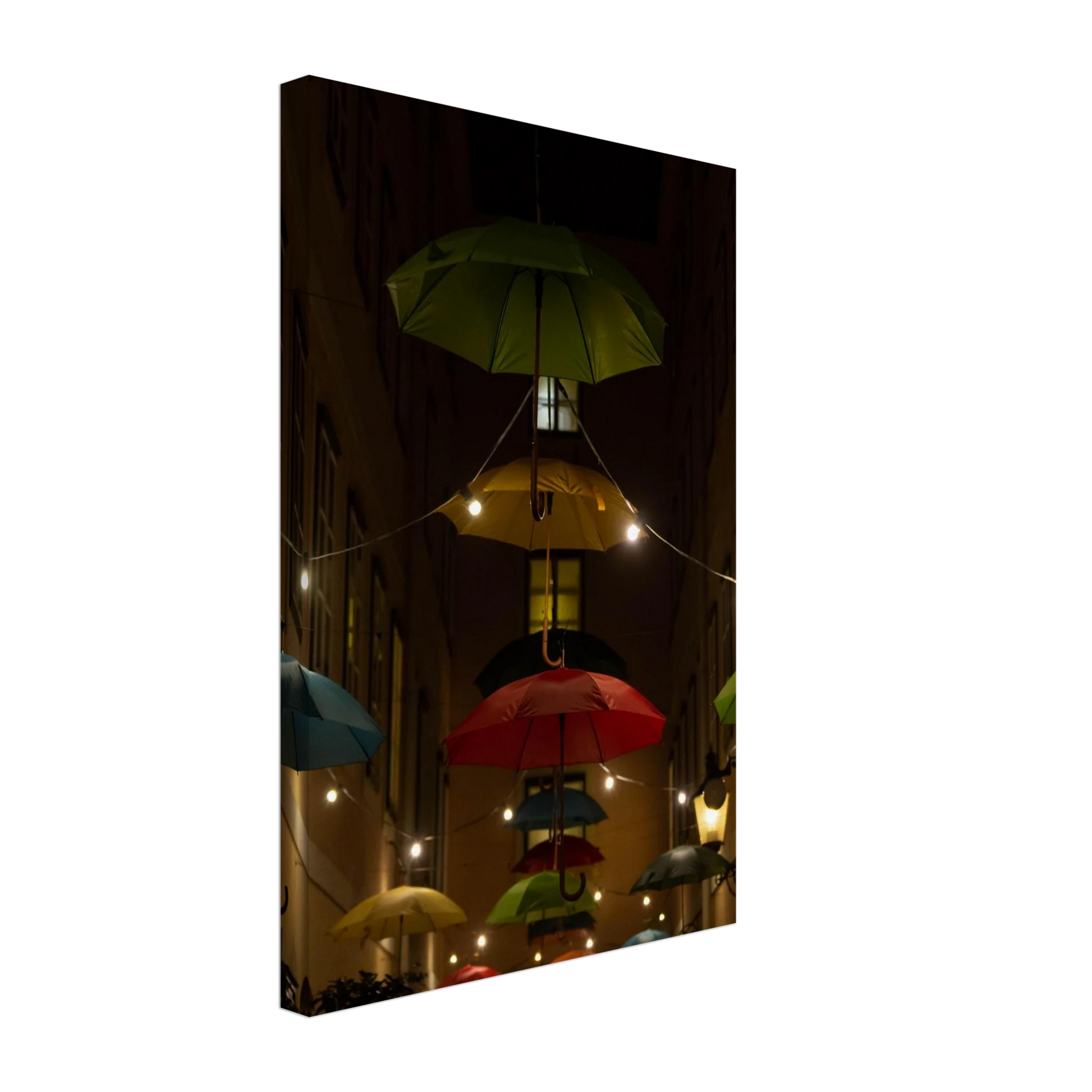 Nighttime street scene with colorful illuminated umbrellas hanging as decoration above a vibrant outdoor area on a Canvas print