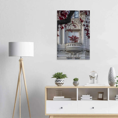 Red leaved tree in autumn colors in front of a historic stone building facade on Canvas Print wall art on the wall in the Livingroom