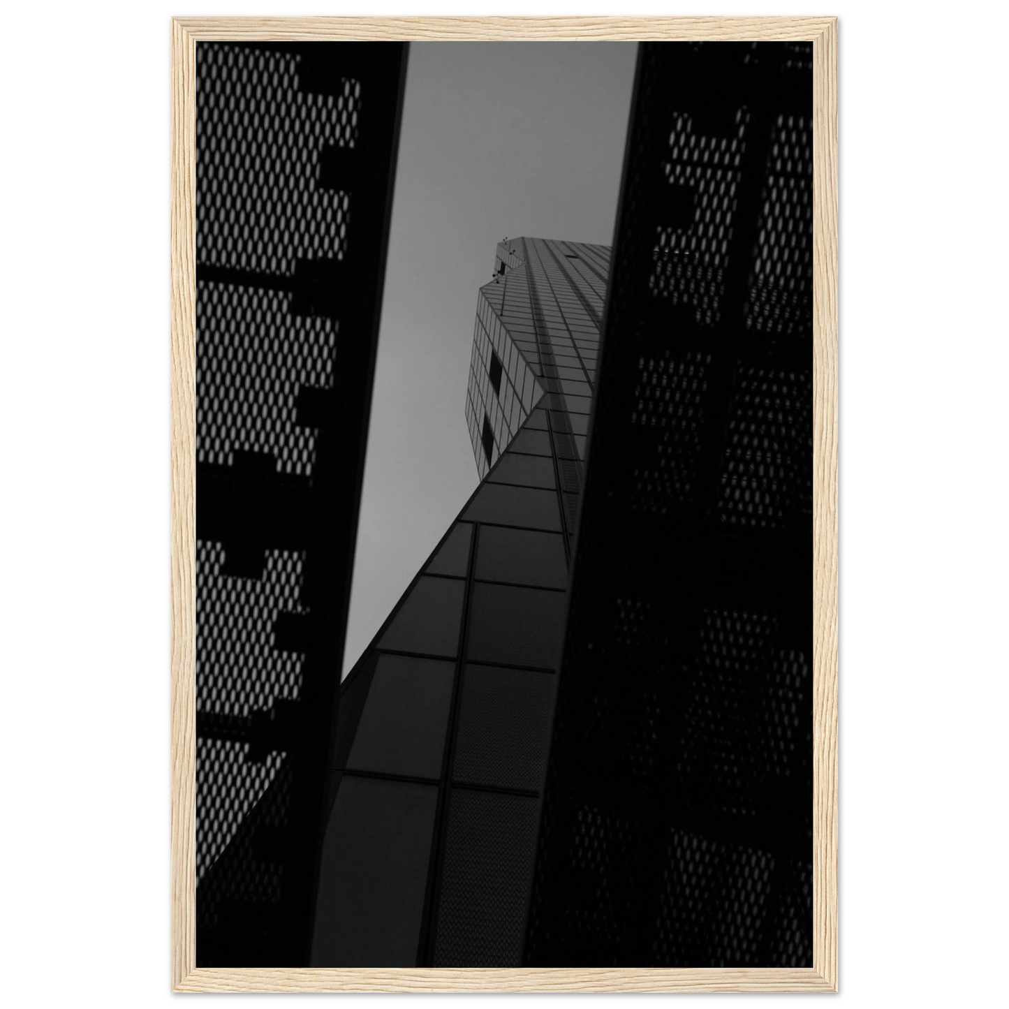 Black and white Low angle view looking up at a tall glass skyscraper framed between two metal structural elements on Wooden frame wall art