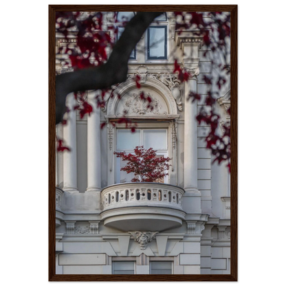 Red leaved tree in autumn colors in front of a historic stone building facade on wooden framed wall art