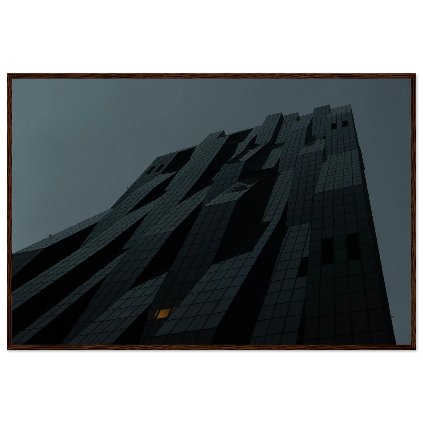 Bluish low angle view of a modern skyscraper with bold geometric lines and dark textured facade on Wooden framed wall art
