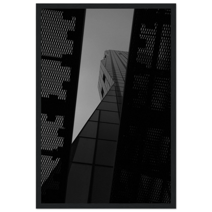 Black and white Low angle view looking up at a tall glass skyscraper framed between two metal structural elements on Wooden frame wall art