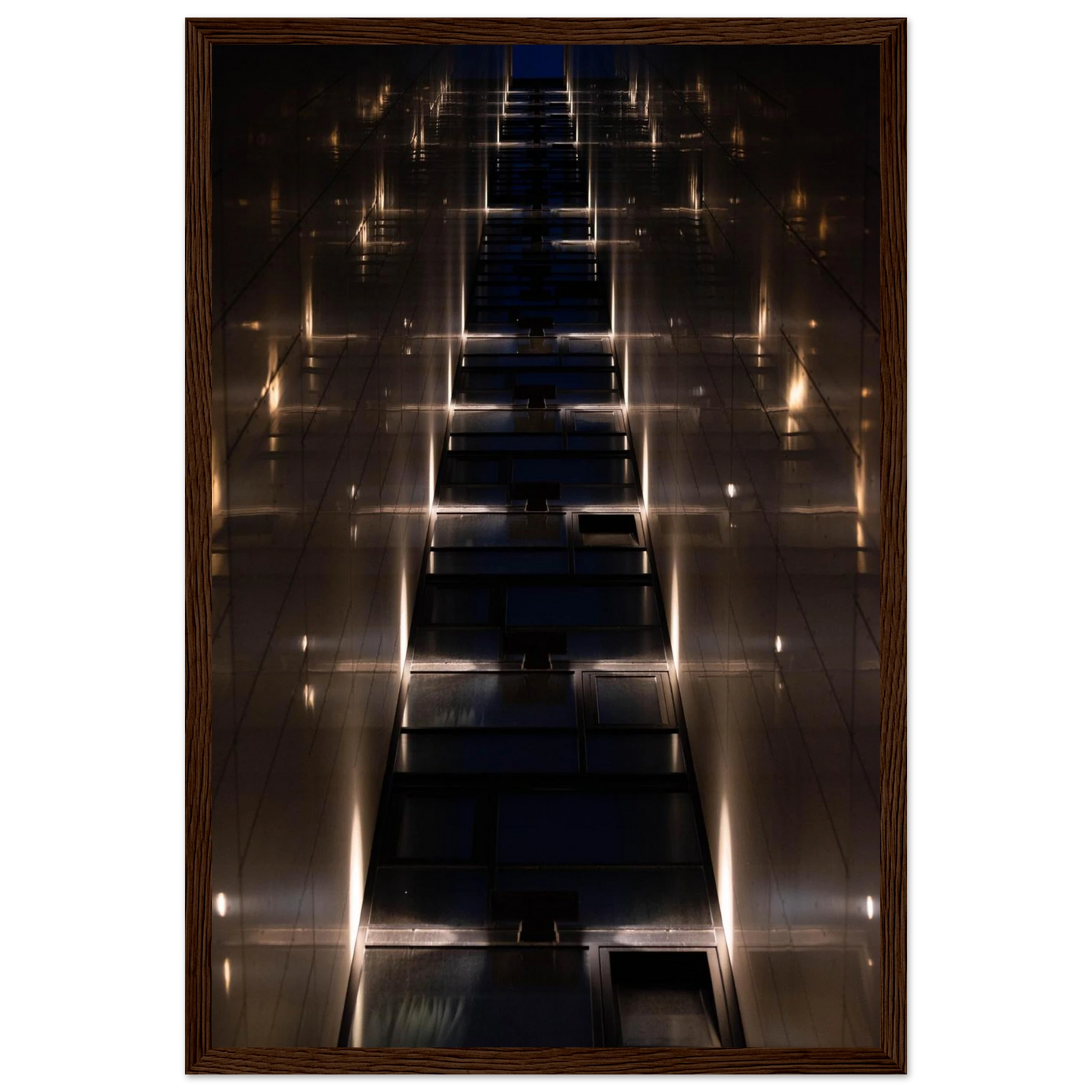 Low angle view looking up a narrow corridor-like passage between two skyscraper walls lined with rows of windows stretching toward the sky on wooden framed wall art