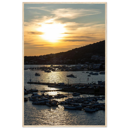 Wooden framed wall art of small boats anchored in a seaside port during Sunset at the harbor
