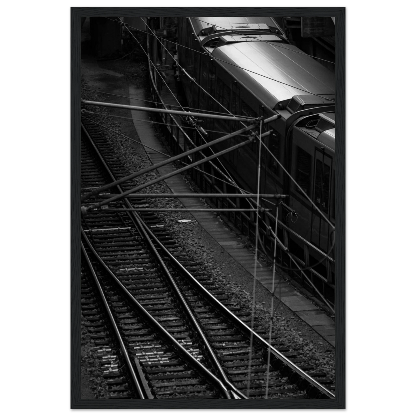 Black and white aerial view of metro train and railway tracks in an urban underground or elevated rail system on wooden framed wall art