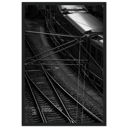 Black and white aerial view of metro train and railway tracks in an urban underground or elevated rail system on wooden framed wall art
