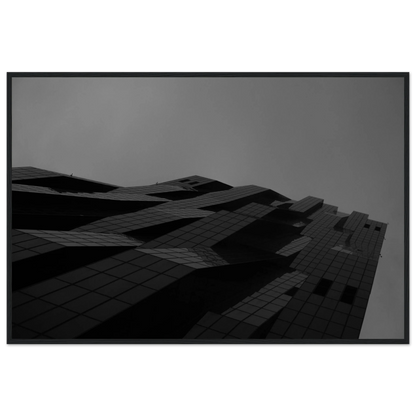 Black and white low angle view of a modern skyscraper with bold geometric lines and dark textured facade on wooden framed wall art