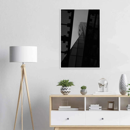 Black and white Low angle view looking up at a tall glass skyscraper framed between two metal structural elements on Wooden frame wall art on the wall in the Livingroom