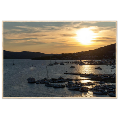 Wooden framed wall art of small boats anchored in a seaside port during Sunset at the harbor