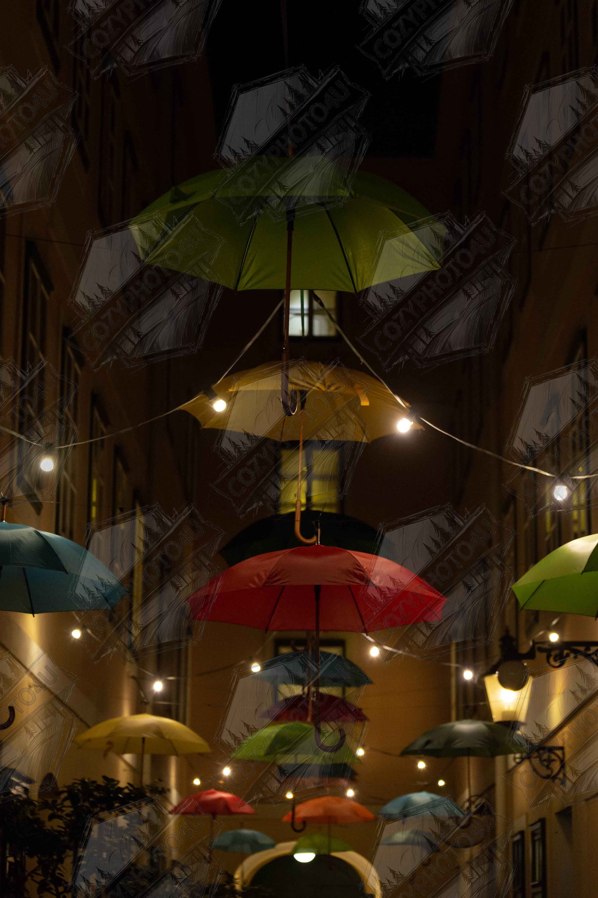 Digital picture art Nighttime street scene with colorful illuminated umbrellas hanging as decoration above a vibrant outdoor area
