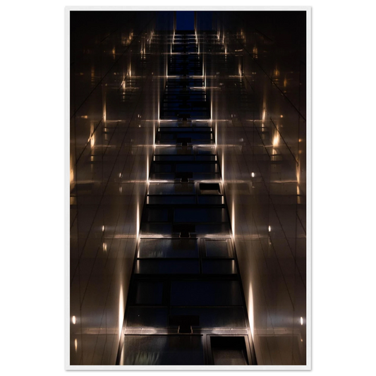 Low angle view looking up a narrow corridor-like passage between two skyscraper walls lined with rows of windows stretching toward the sky on wooden framed wall art