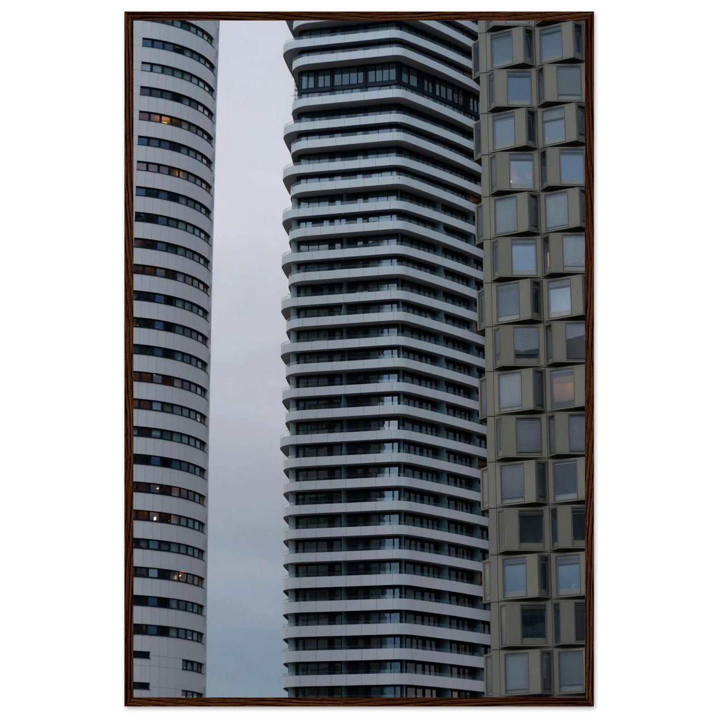 Modern high rise tower buildings with glass and steel facade reaching into the sky on wodden framed wall art