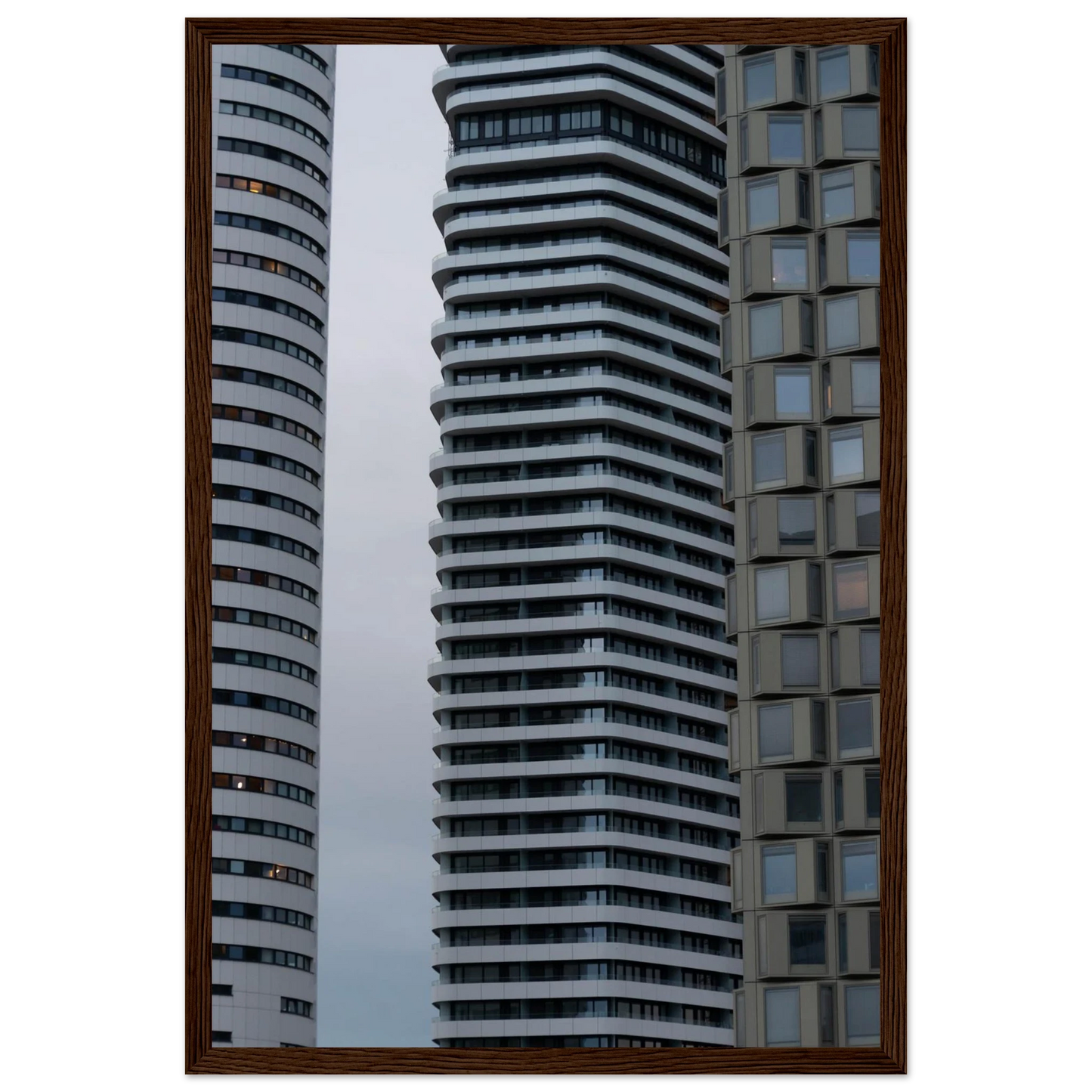 Modern high rise tower buildings with glass and steel facade reaching into the sky on wodden framed wall art