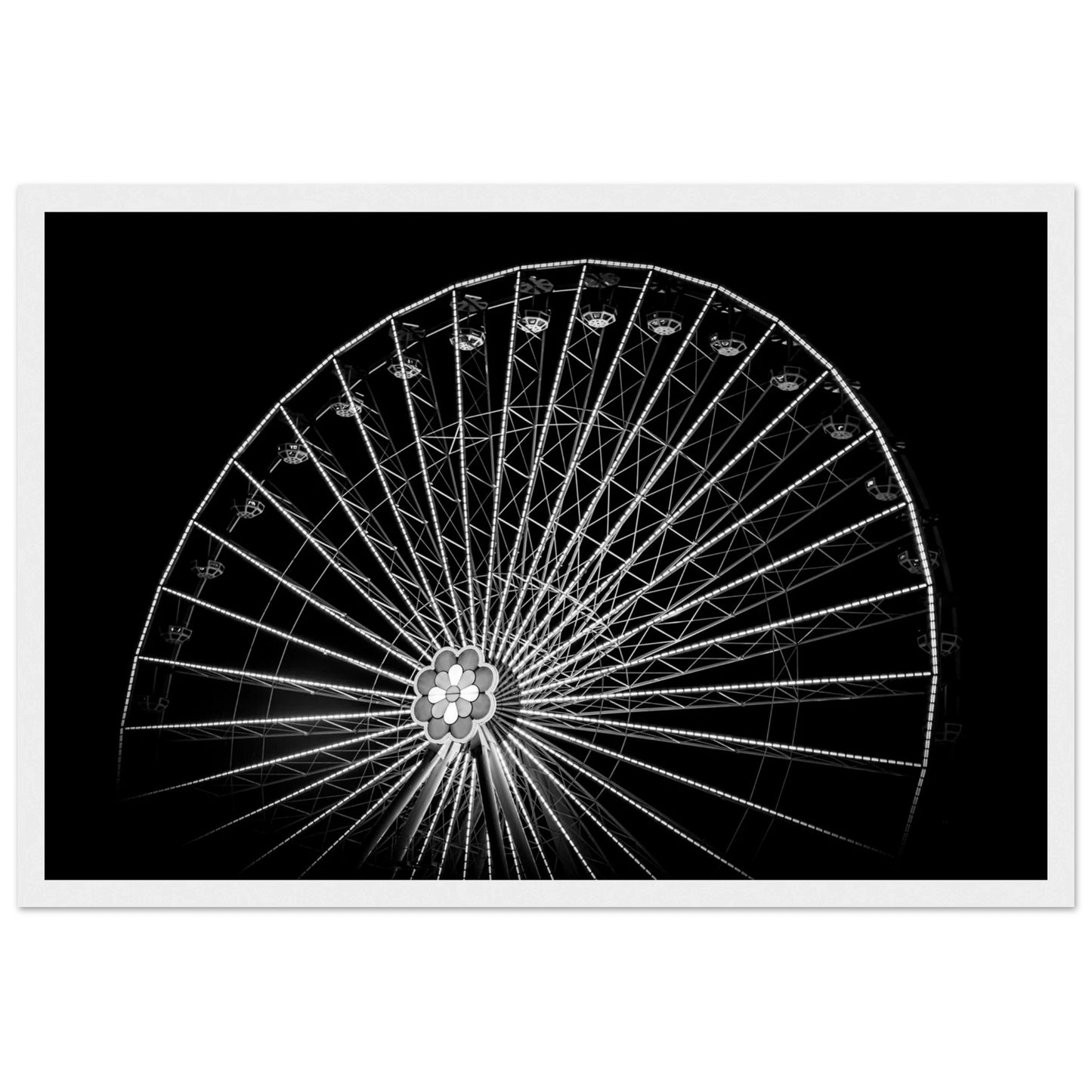Black and white night photo of the Vienna Prater Giant Ferris Wheel (Wiener Riesenrad) with illuminated spokes forming a circular pattern against the dark sky on wooden framed wall art