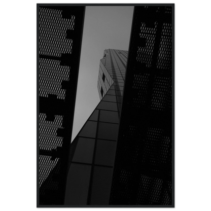 Black and white Low angle view looking up at a tall glass skyscraper framed between two metal structural elements on Wooden frame wall art
