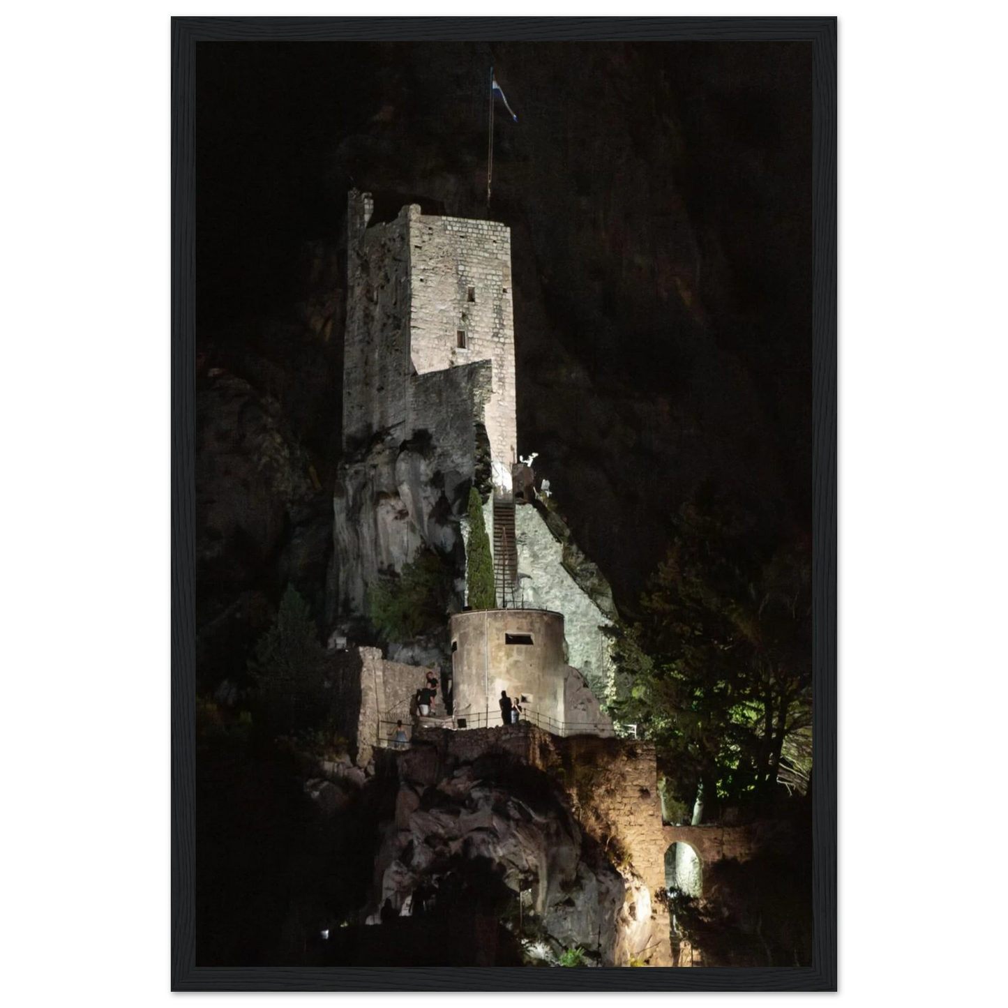 Wooden framed wall art of an ancient stone bastion decorated with green climbing plants against a dark background in Shadow Keep