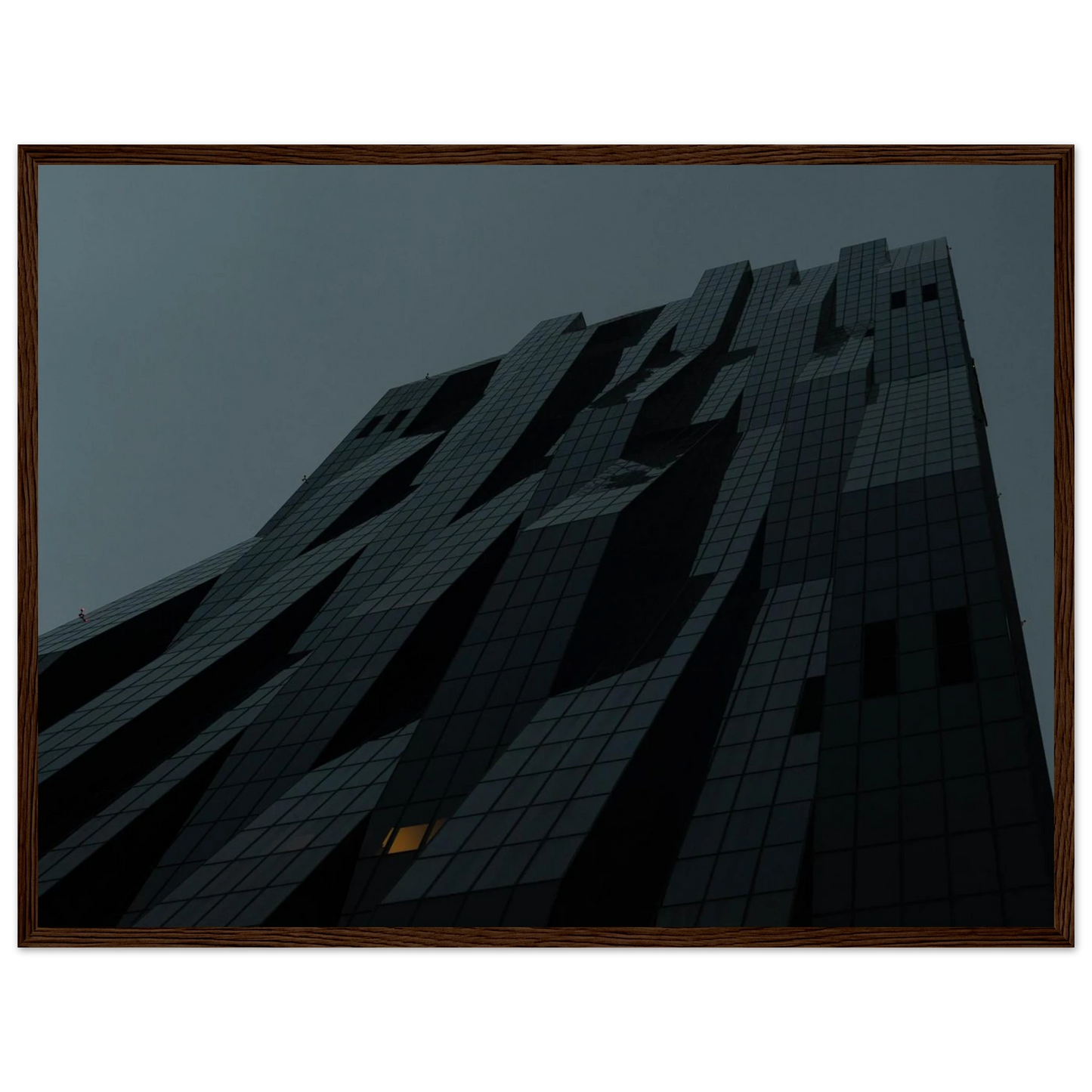 Bluish low angle view of a modern skyscraper with bold geometric lines and dark textured facade on Wooden framed wall art