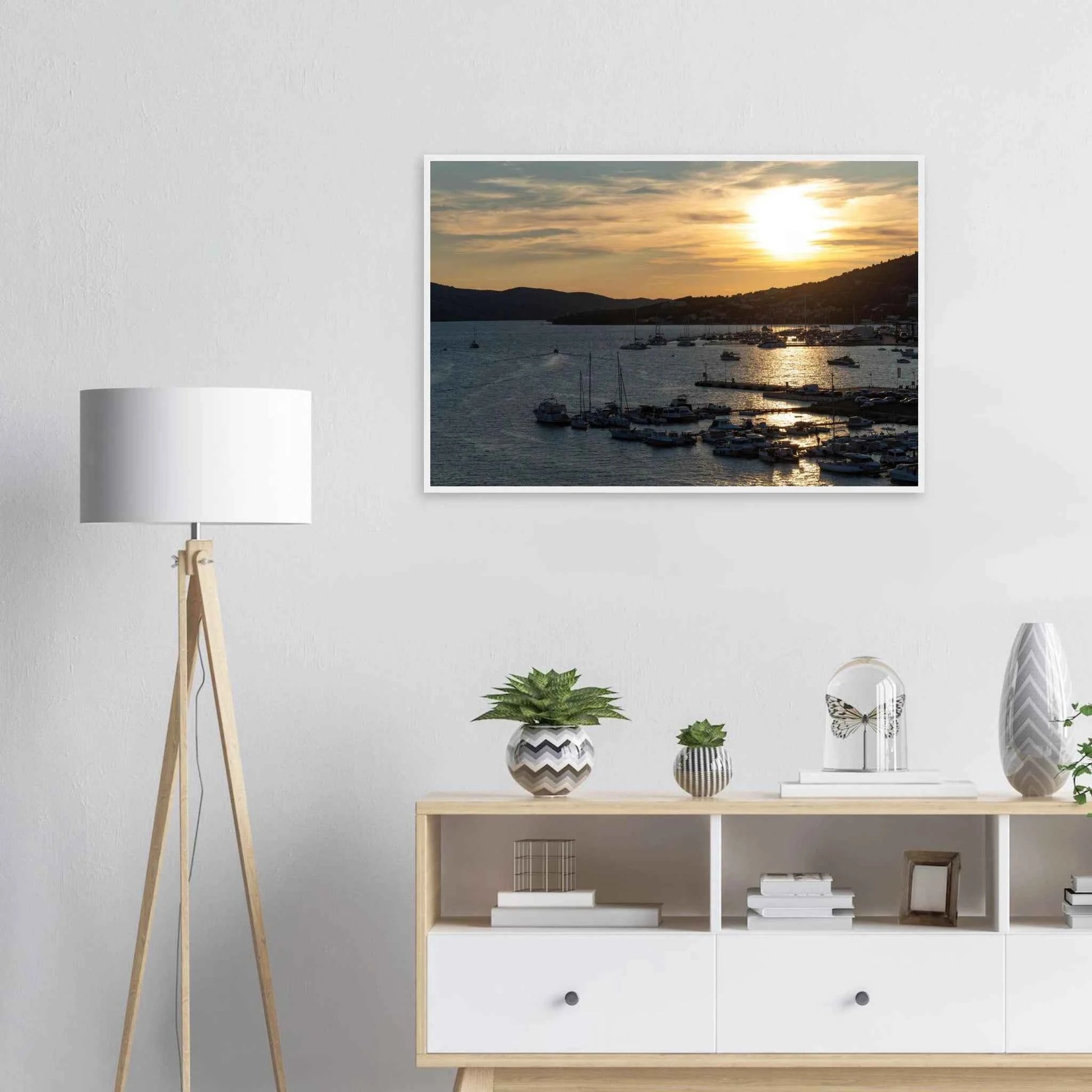 Wooden framed wall art of small boats anchored in a seaside port during Sunset at the harbor on the wall in the Livingroom