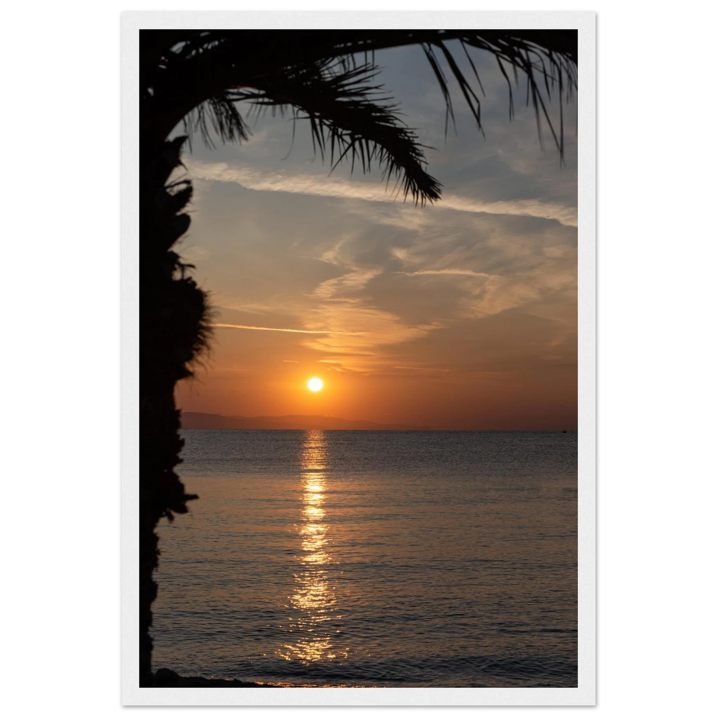 Wooden framed wall art Sunset over calm water with golden reflections, framed by tree branches in a peaceful natural landscape