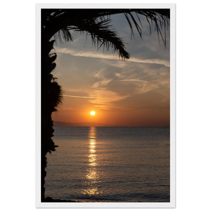 Wooden framed wall art Sunset over calm water with golden reflections, framed by tree branches in a peaceful natural landscape