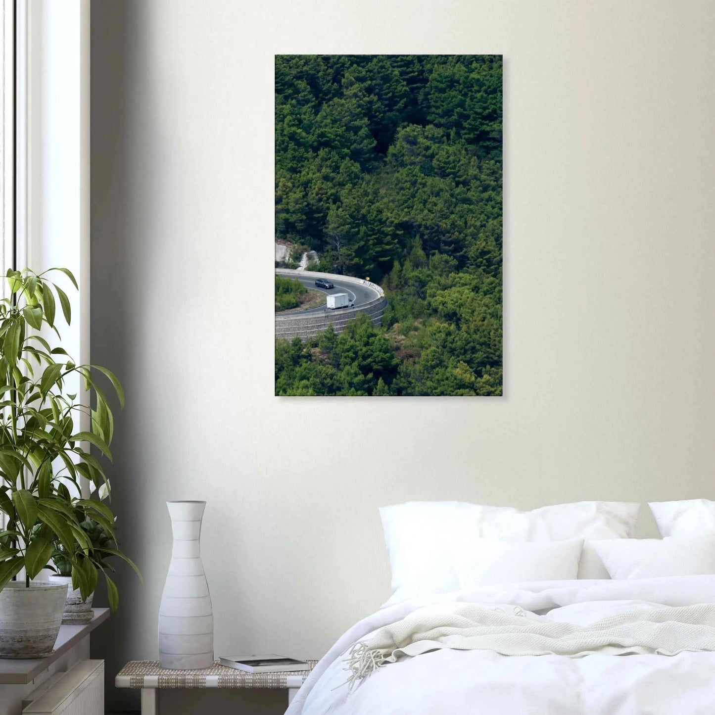 Aerial view of a winding road curve with cars surrounded by lush green forest landscape on Canvas print wall art on the wall in the Bedroom