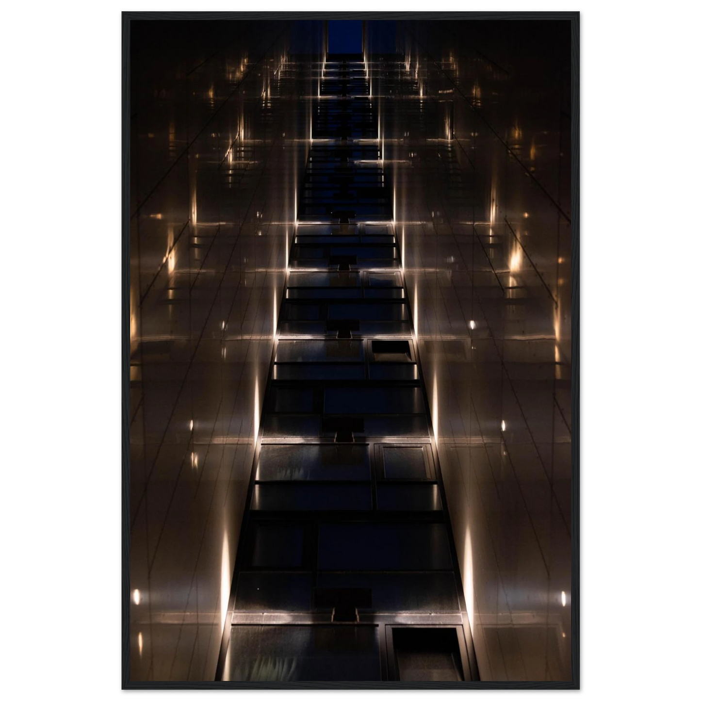 Low angle view looking up a narrow corridor-like passage between two skyscraper walls lined with rows of windows stretching toward the sky on wooden framed wall art