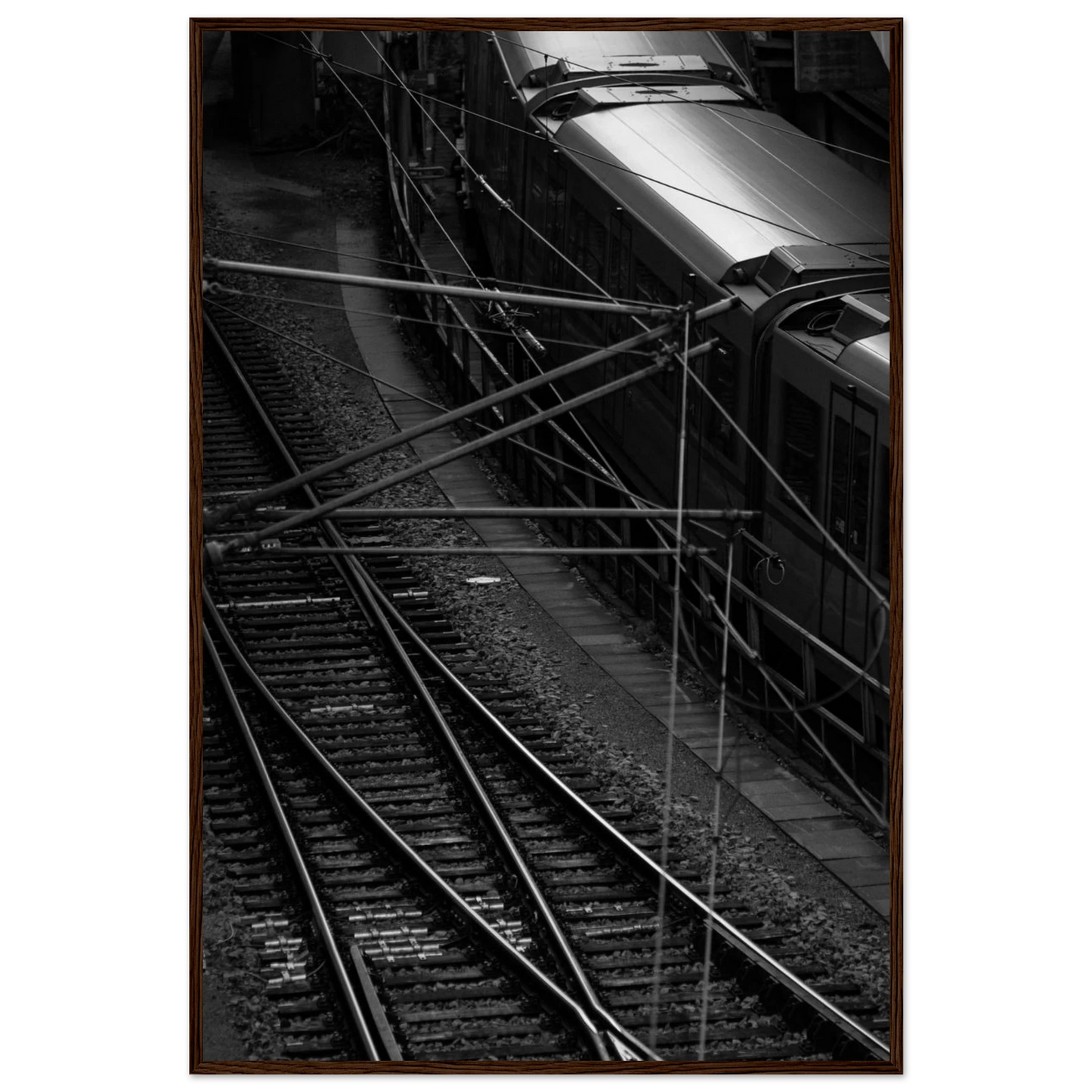 Black and white aerial view of metro train and railway tracks in an urban underground or elevated rail system on wooden framed wall art