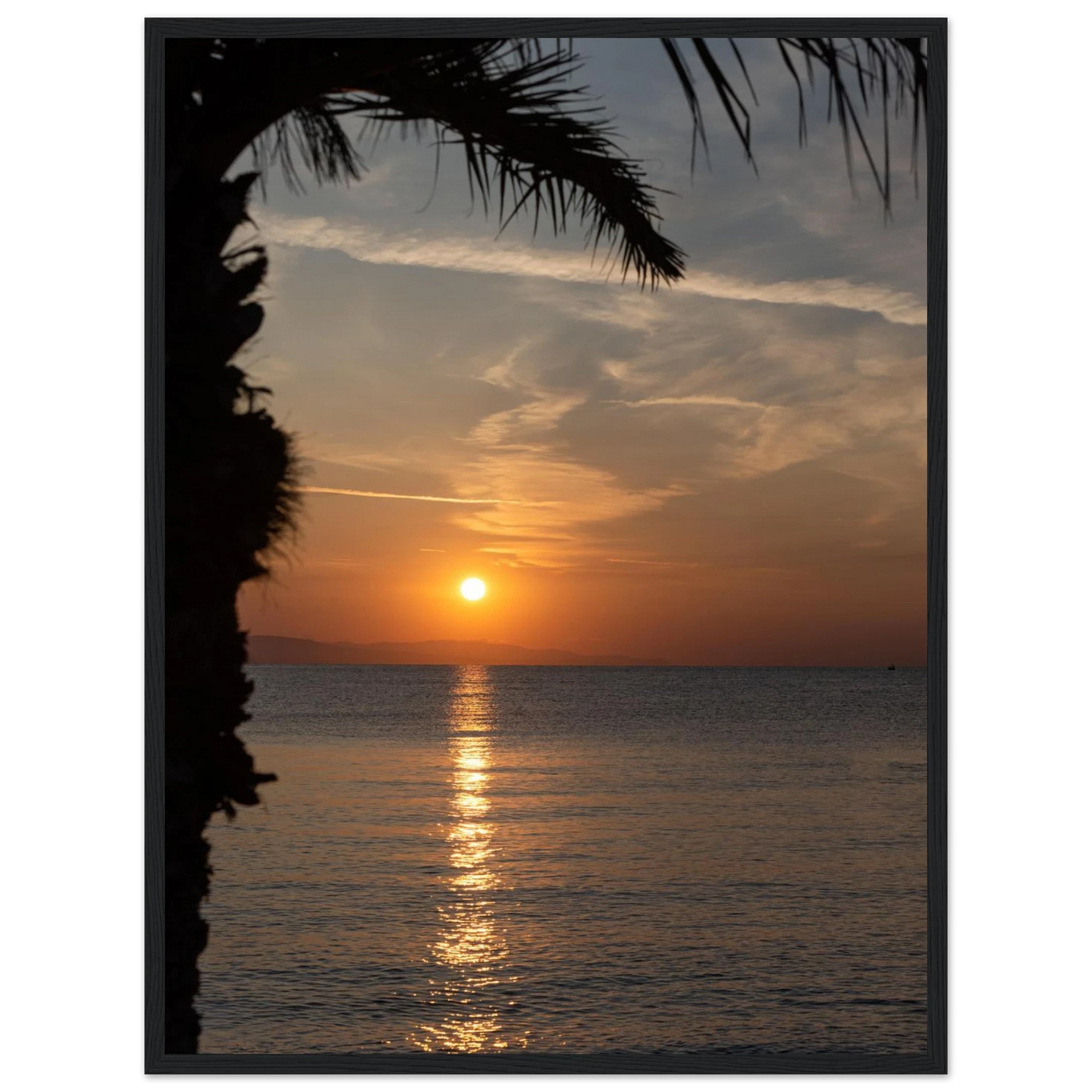 Wooden framed wall art Sunset over calm water with golden reflections, framed by tree branches in a peaceful natural landscape