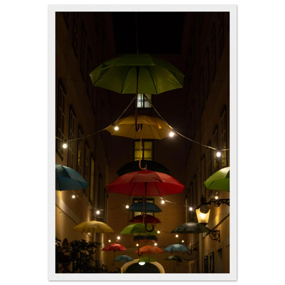 Nighttime street scene with colorful illuminated umbrellas hanging as decoration above a vibrant outdoor area on a wooden frame wall art