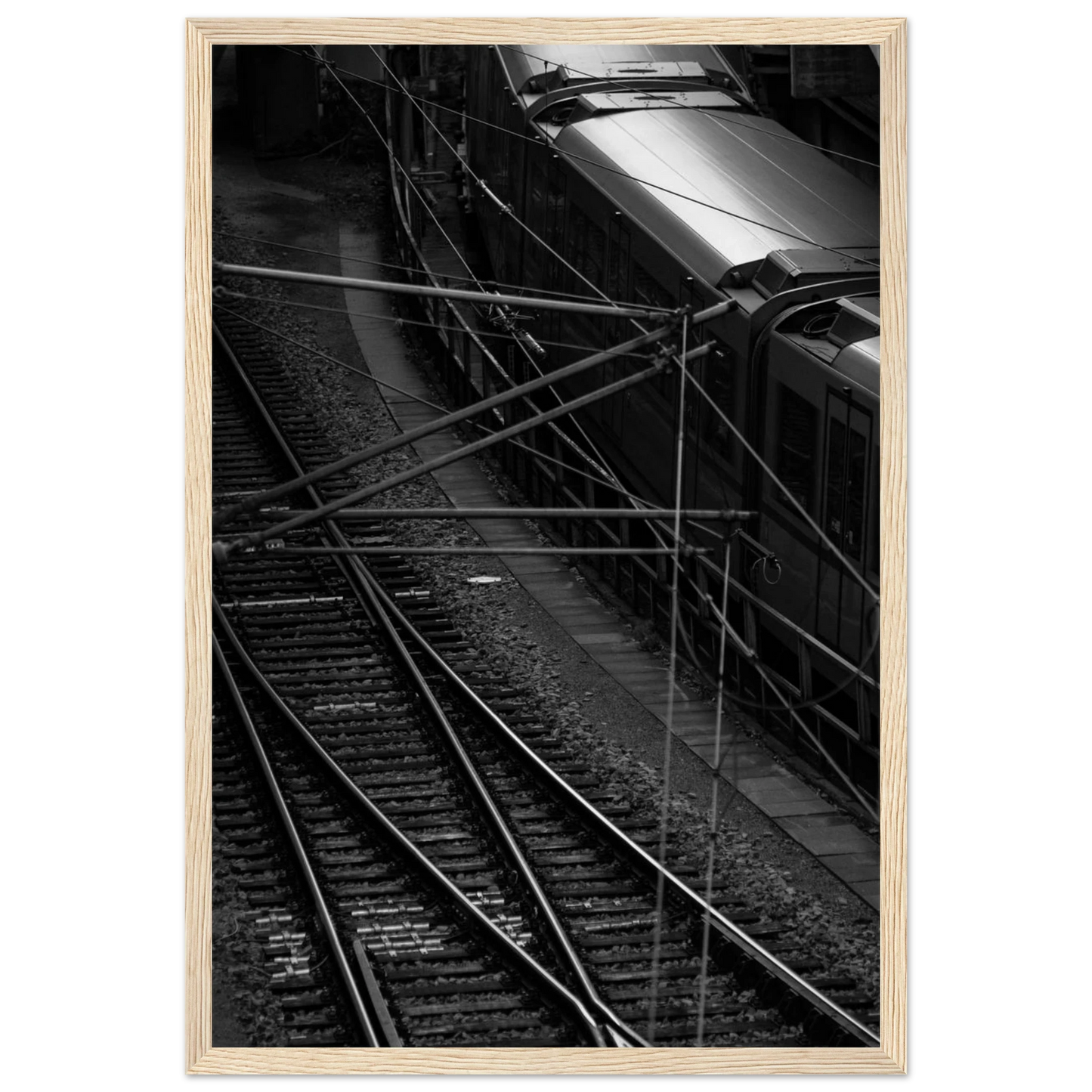 Black and white aerial view of metro train and railway tracks in an urban underground or elevated rail system on wooden framed wall art