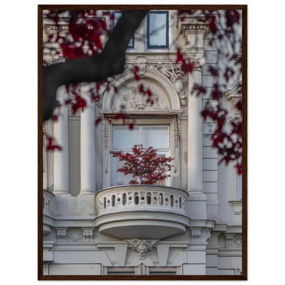 Red leaved tree in autumn colors in front of a historic stone building facade on wooden framed wall art
