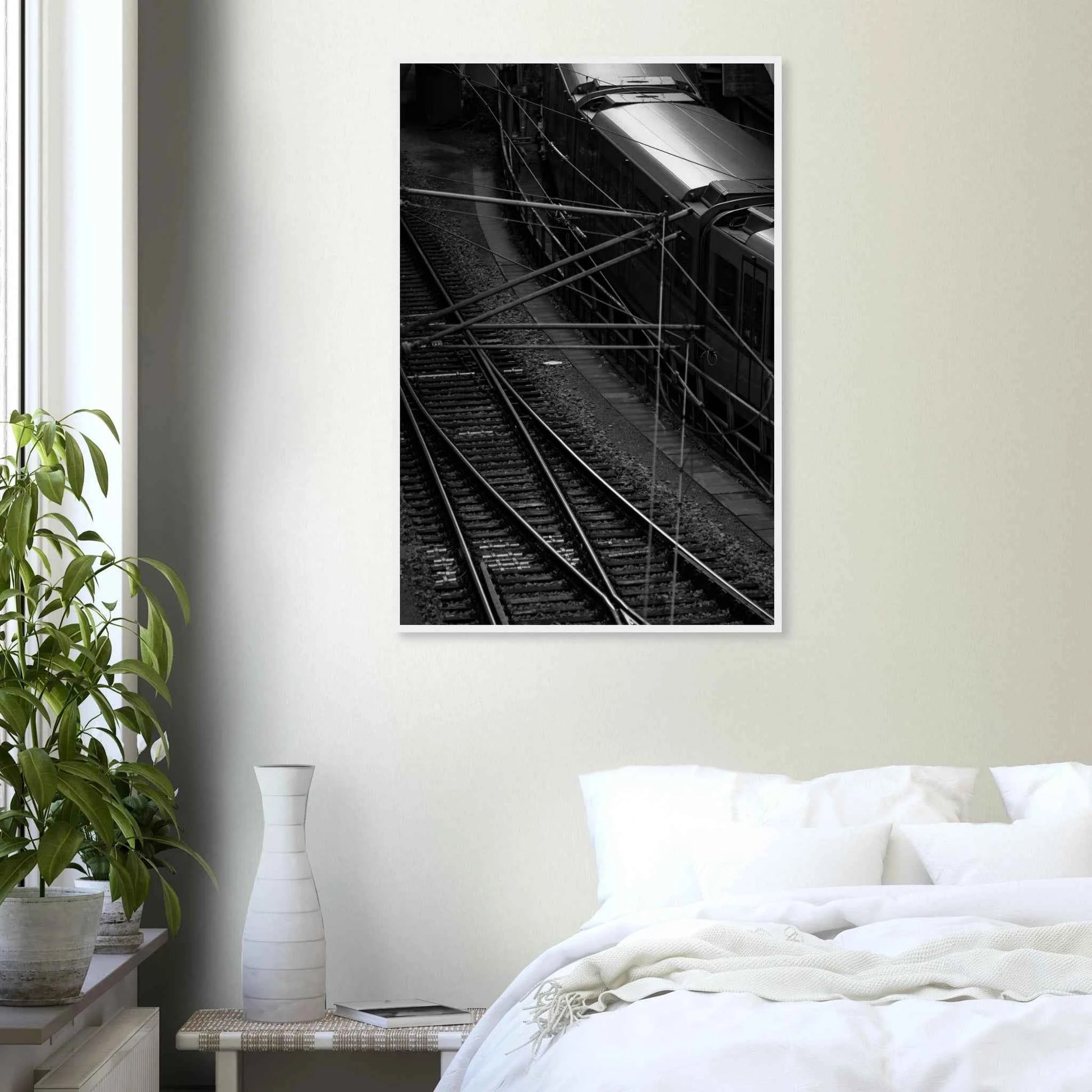 Black and white aerial view of metro train and railway tracks in an urban underground or elevated rail system on wooden framed wall art on the wall in the Bedroom