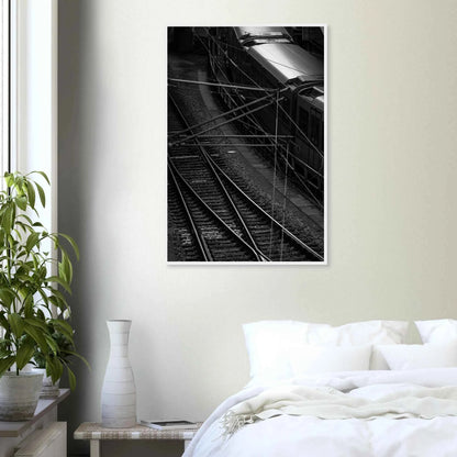 Black and white aerial view of metro train and railway tracks in an urban underground or elevated rail system on wooden framed wall art on the wall in the Bedroom