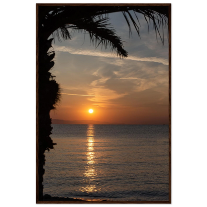 Wooden framed wall art Sunset over calm water with golden reflections, framed by tree branches in a peaceful natural landscape