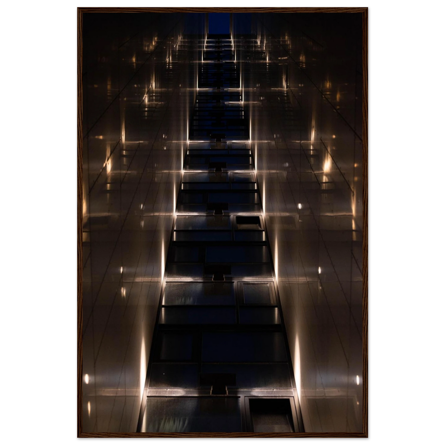 Low angle view looking up a narrow corridor-like passage between two skyscraper walls lined with rows of windows stretching toward the sky on wooden framed wall art