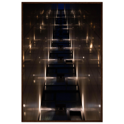 Low angle view looking up a narrow corridor-like passage between two skyscraper walls lined with rows of windows stretching toward the sky on wooden framed wall art
