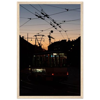 Wooden framed wall art featuring a tram the Nightline driving between houses under power lines during a golden sunset