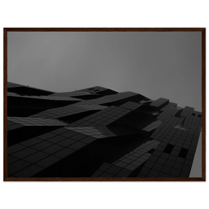 Black and white low angle view of a modern skyscraper with bold geometric lines and dark textured facade on wooden framed wall art