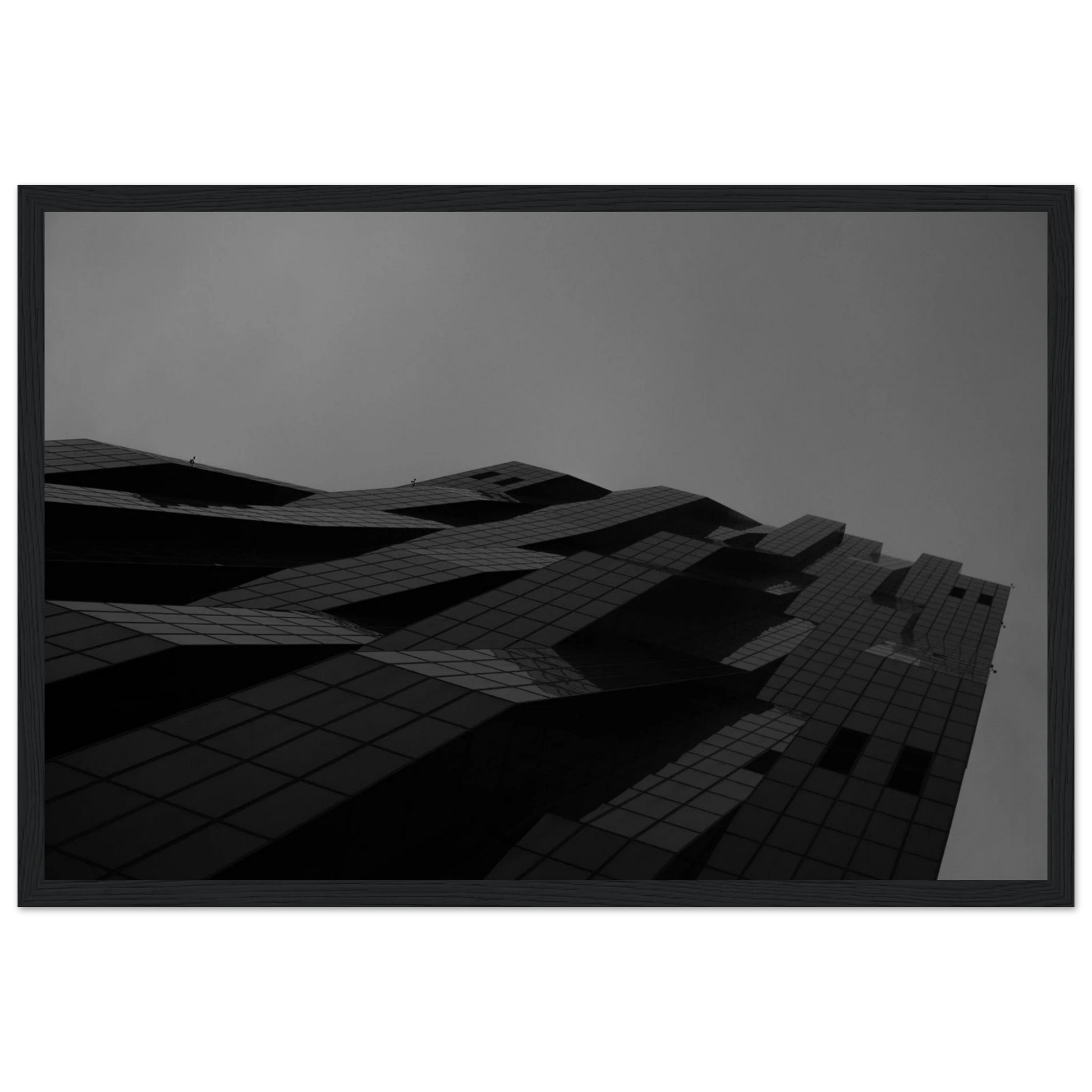 Black and white low angle view of a modern skyscraper with bold geometric lines and dark textured facade on wooden framed wall art