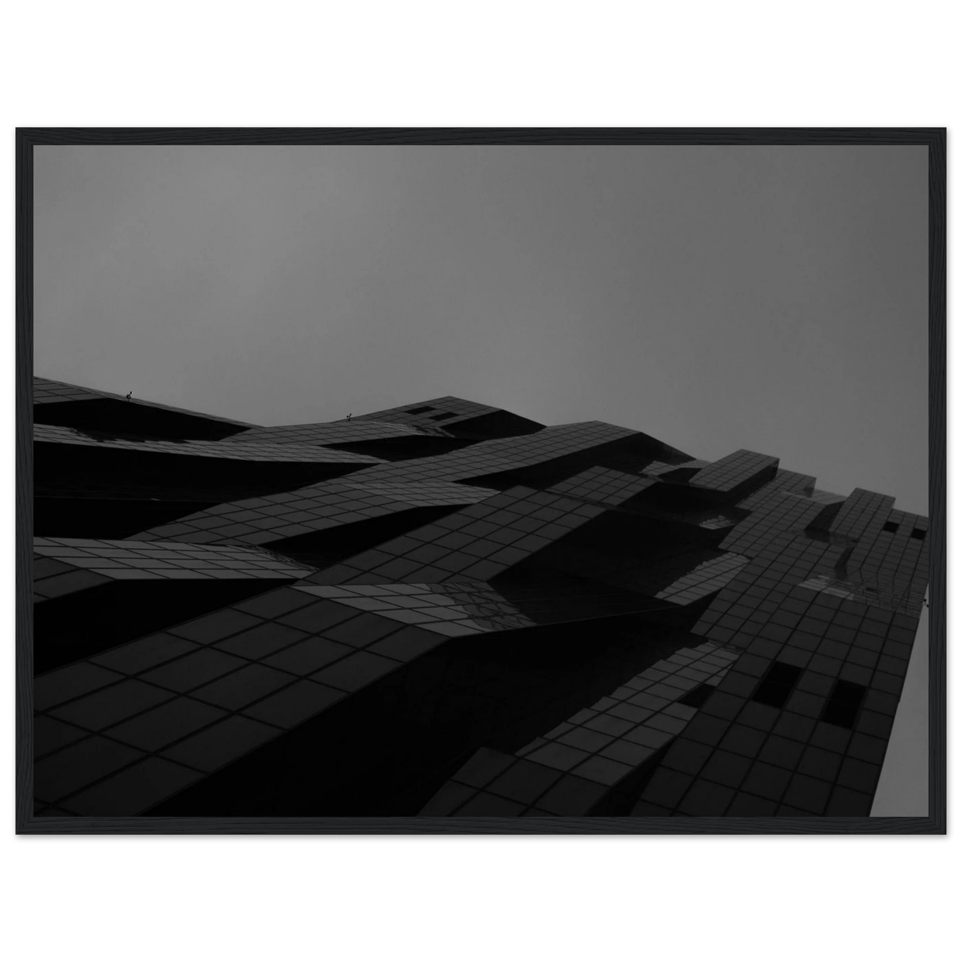 Black and white low angle view of a modern skyscraper with bold geometric lines and dark textured facade on wooden framed wall art
