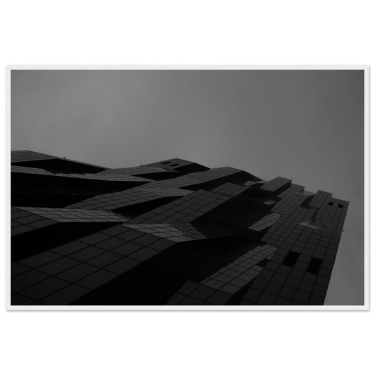Black and white low angle view of a modern skyscraper with bold geometric lines and dark textured facade on wooden framed wall art