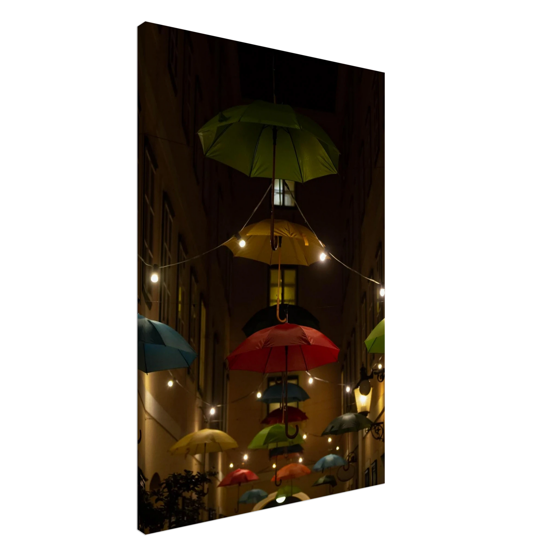 Nighttime street scene with colorful illuminated umbrellas hanging as decoration above a vibrant outdoor area on a Canvas print
