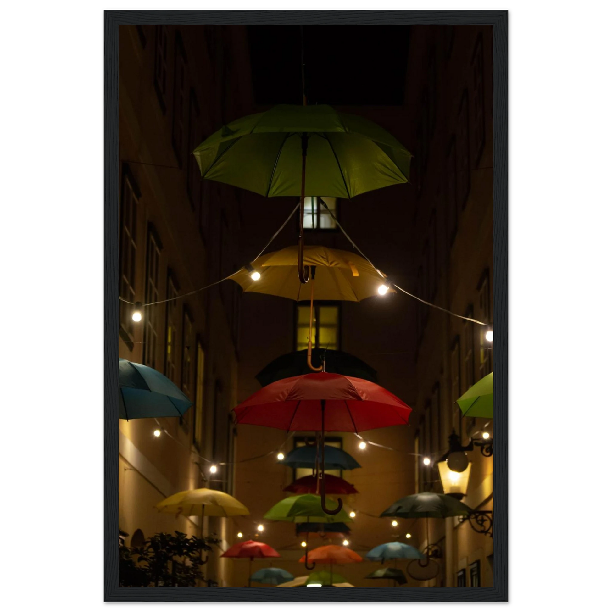 Nighttime street scene with colorful illuminated umbrellas hanging as decoration above a vibrant outdoor area on a wooden frame wall art