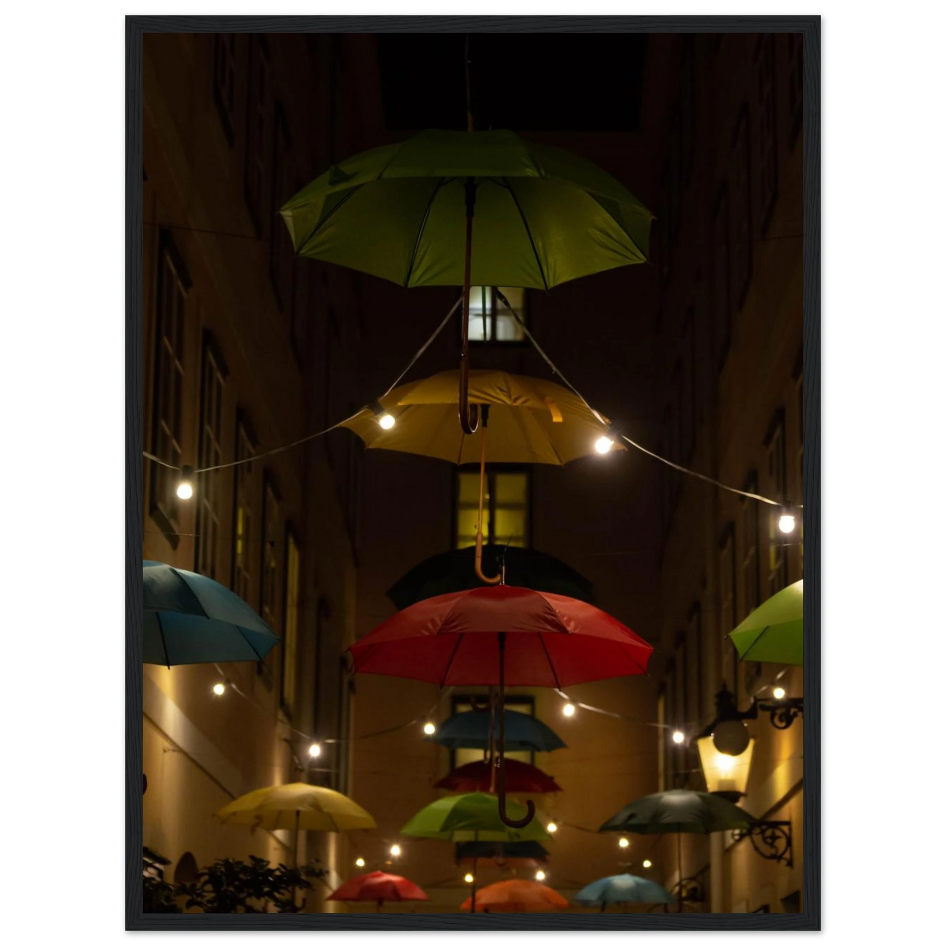 Nighttime street scene with colorful illuminated umbrellas hanging as decoration above a vibrant outdoor area on a wooden frame wall art