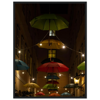 Nighttime street scene with colorful illuminated umbrellas hanging as decoration above a vibrant outdoor area on a wooden frame wall art