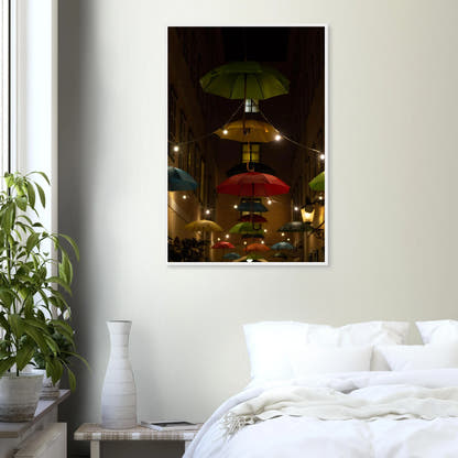 Nighttime street scene with colorful illuminated umbrellas hanging as decoration above a vibrant outdoor area on a wooden frame wall art on the wall in the Bedroom