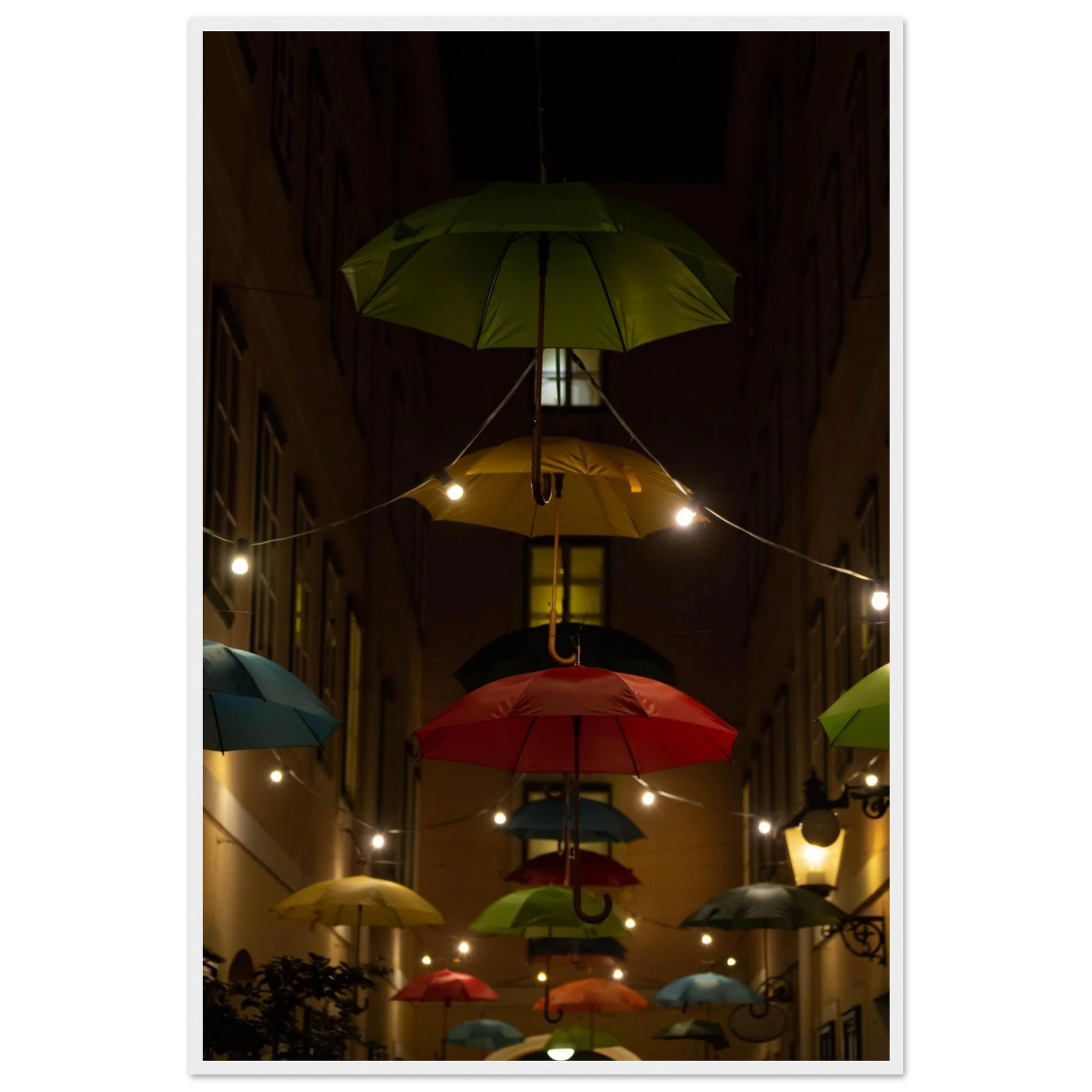 Nighttime street scene with colorful illuminated umbrellas hanging as decoration above a vibrant outdoor area on a wooden frame wall art